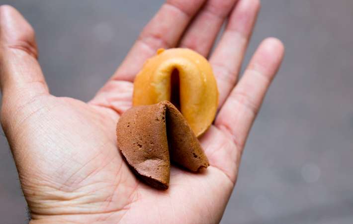 open palm holding two fortune cookies