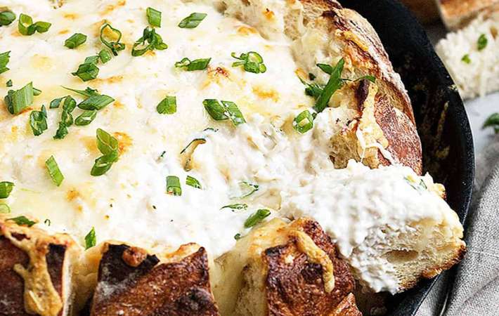 warm skillet crab dip in a sourdough bread bowl can go straight from the oven to the table