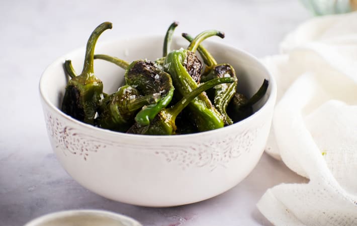 blistered shishito peppers are a quick vegan appetizer