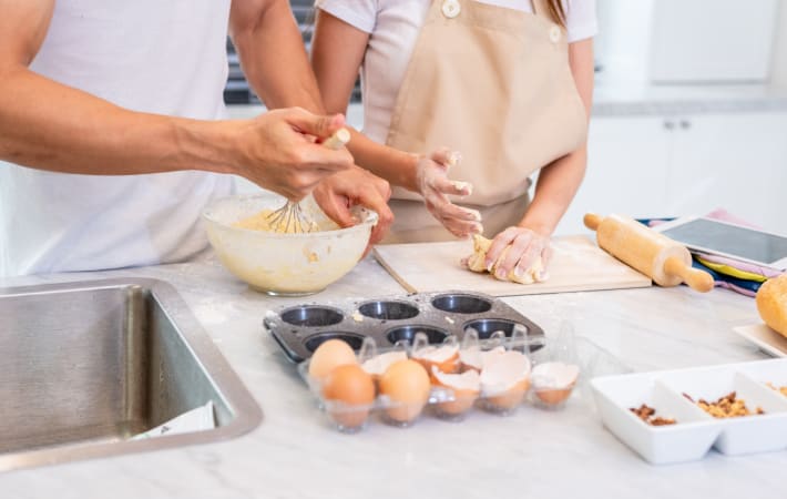 A couple enjoying a cake baking class in London