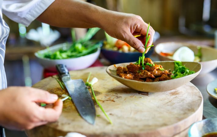 Preparing a dish in a beginner cooking class in London