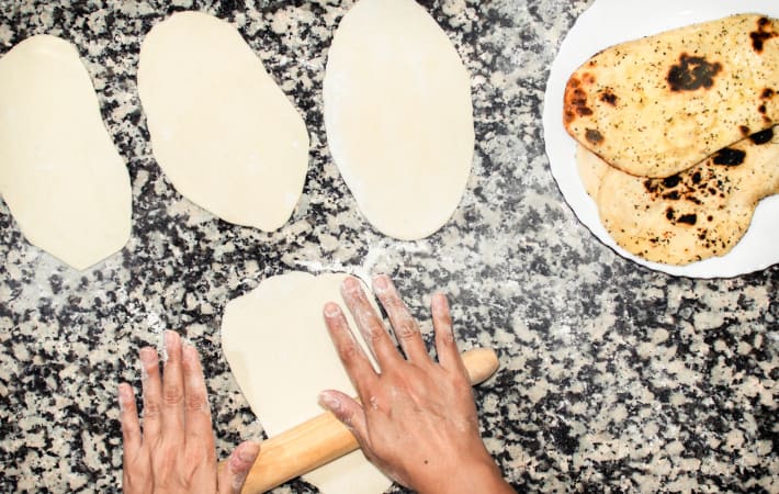 Preparing naan during an Indian cooking class in London