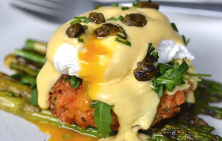 salmon cake eggs benedict with lemon hollandaise & crispy capers are a great way to elevate this gluten free dairy free breakfast