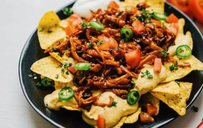 loaded vegan nachos with mushroom pulled pork is a savory and satisfying vegan appetizer