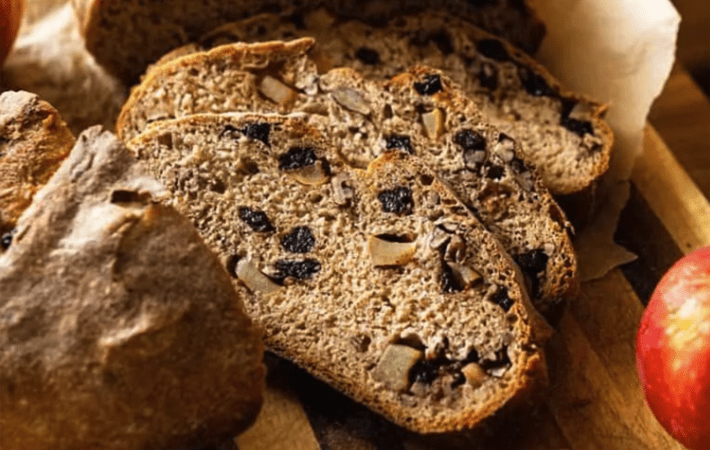 crusty apple cranberry dutch oven bread is a rustic, crusty loaf with a soft interior