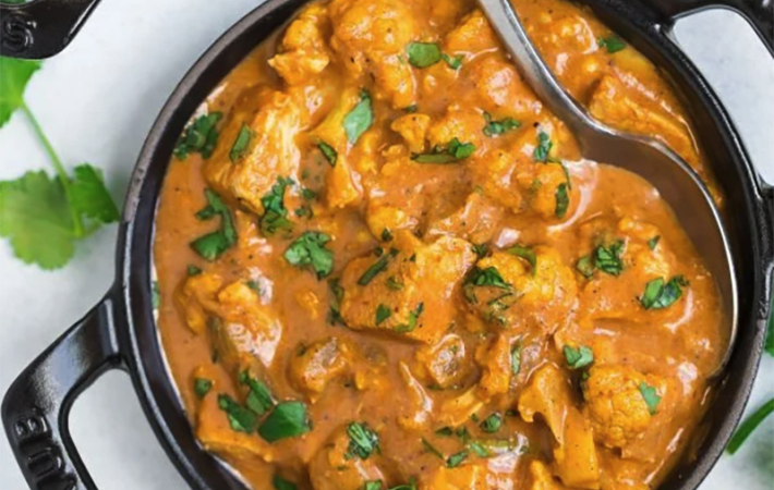 slow cooker butter chicken features a rich, creamy curry