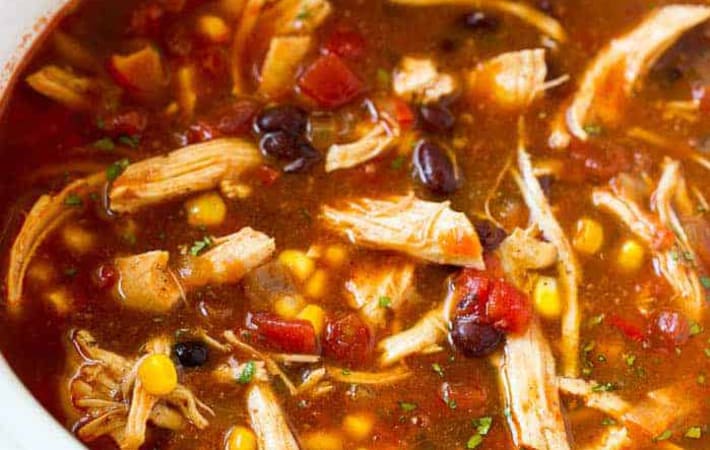 slow cooker chicken enchilada soup is spicy, smokey and packed with protein