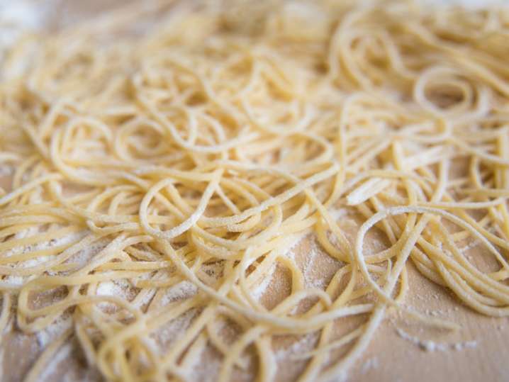 homemade spaghetti on a floured cutting board Shot