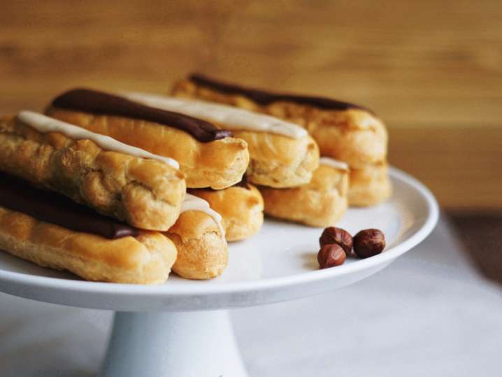 tiered plate layered with frosted eclairs Shot