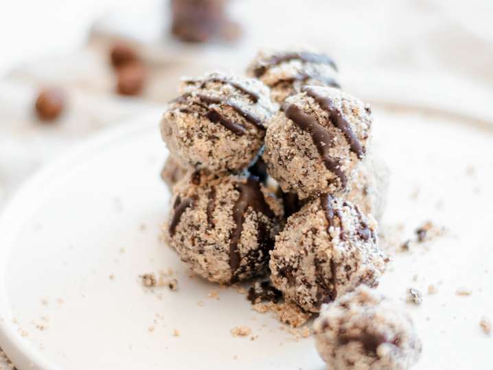 a stack of chocolate truffles with chocolate drizzle on a plate Shot