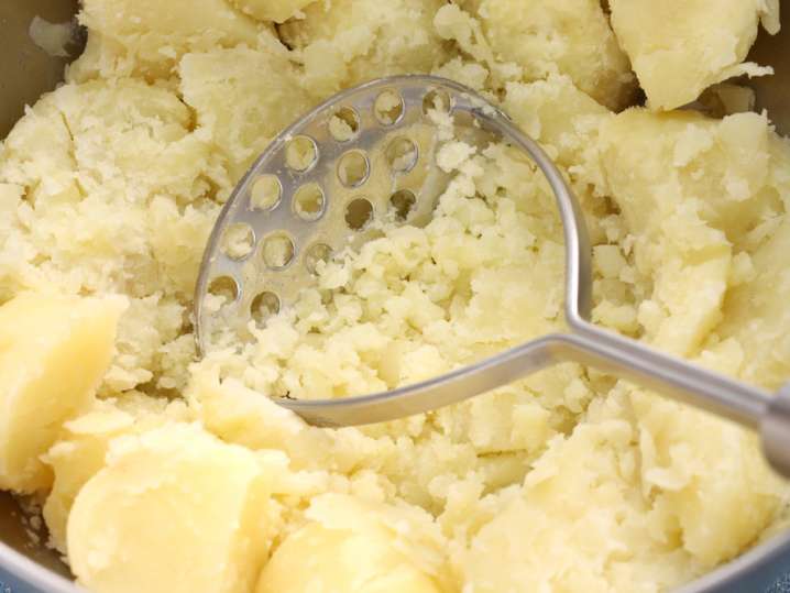 mashing potatoes for samosa filling Shot