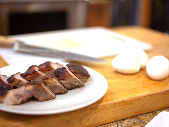 cutting board with pork belly and hard boiled eggs Shot