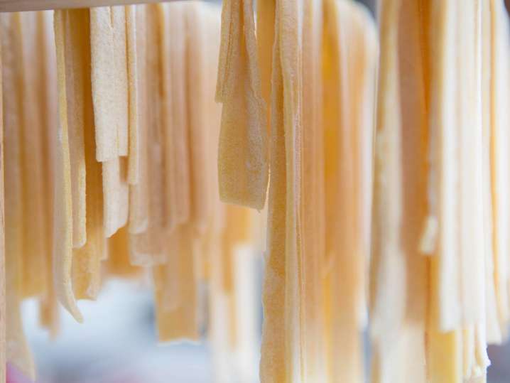linguine hanging on a pasta rack Shot