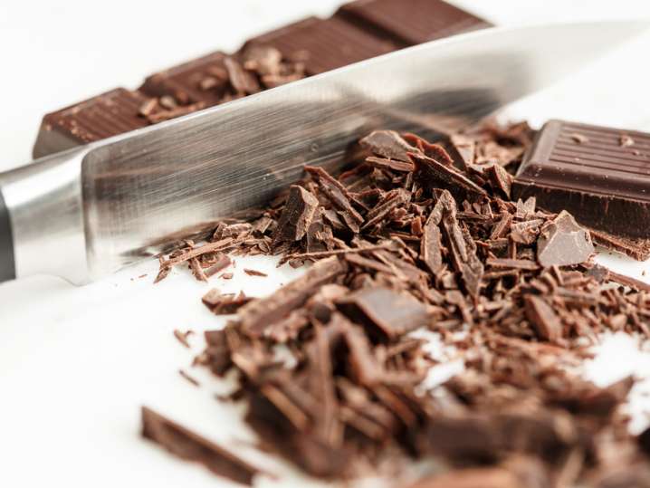 chocolate being shaved with a knife Shot