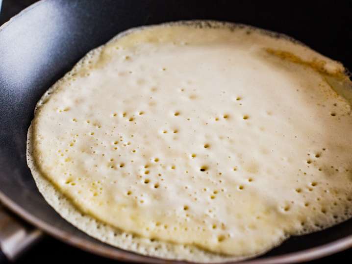 crepe batter cooking in a frying pan Shot