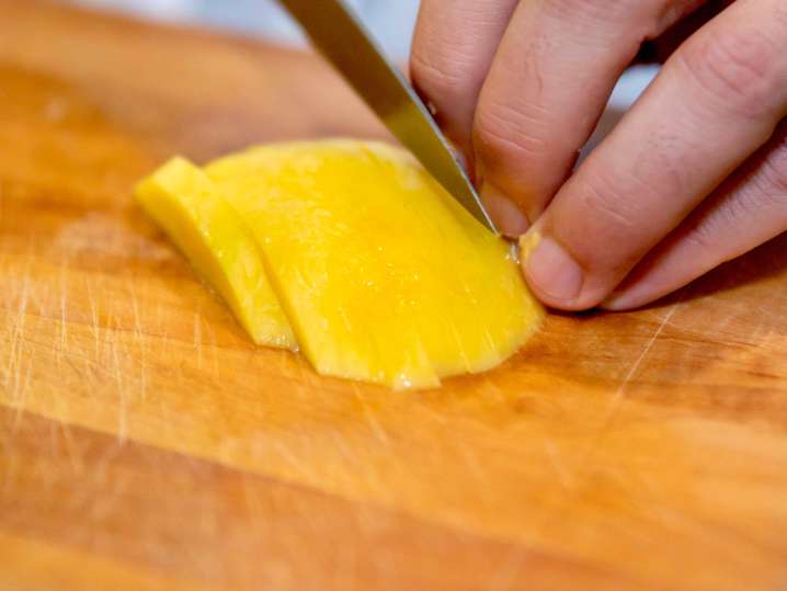 chef slicing mango Shot