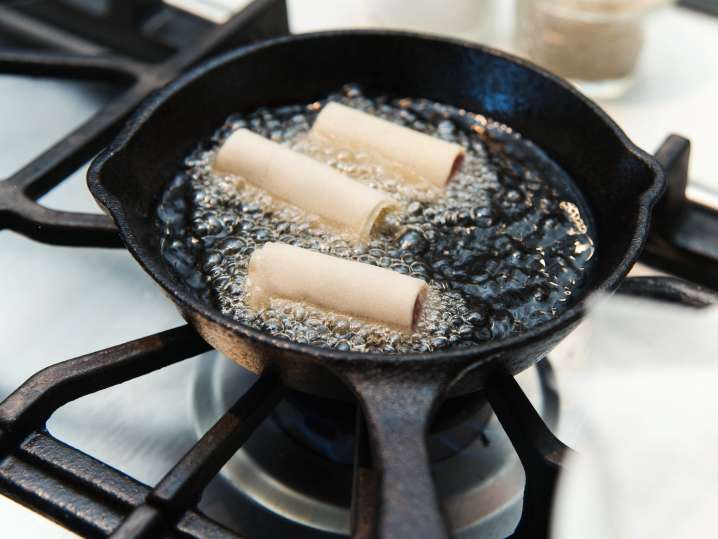 lumpia frying in hot oil Shot