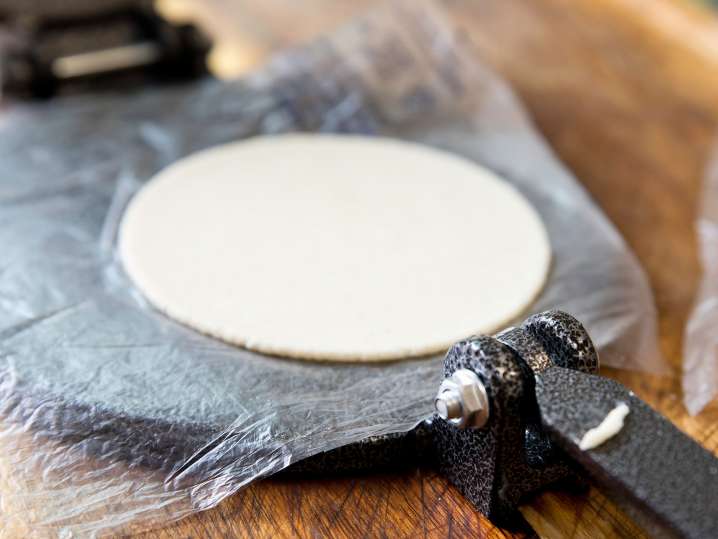 homemade tortilla in a tortilla press Shot