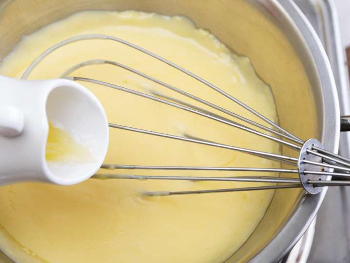 pouring butter into hollandaise sauce Shot