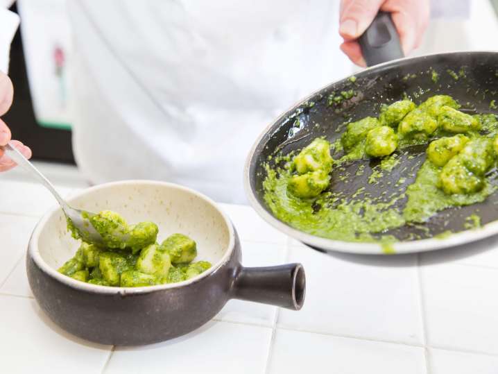 dropping homemade gnocchi into boiling water Shot