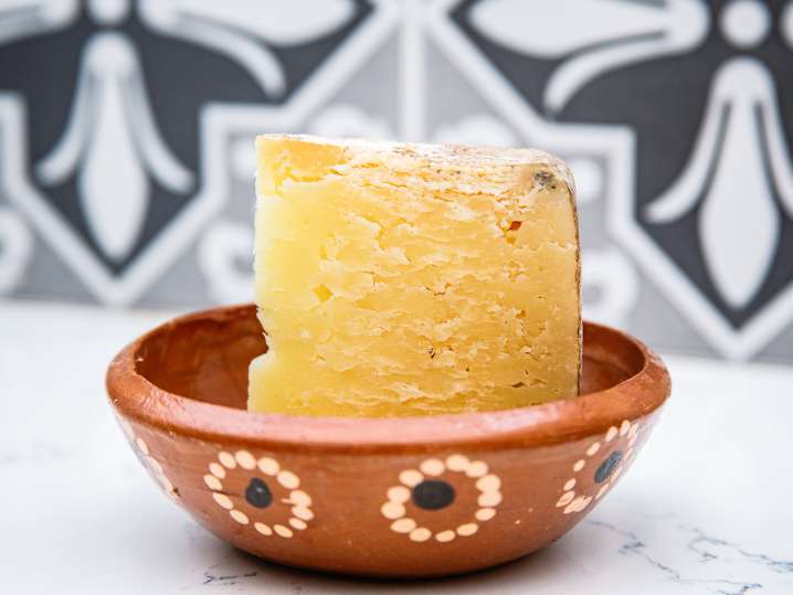 block of parmesan cheese in a bowl Shot