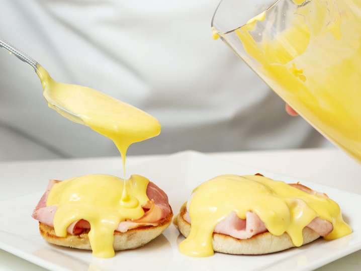 Los Angeles - drizzling homemade hollandaise onto parma ham and english muffins Shot