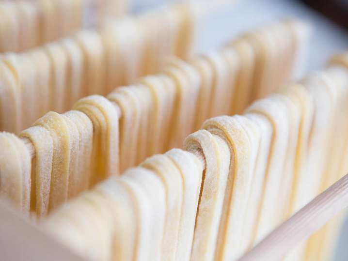 fresh cut pasta drying on a rack Shot