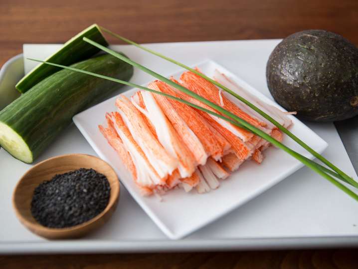 chef's knife, fresh tuna, and scallions on a cutting board Shot