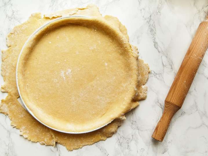 pie dough rolled out and placed over a pan Shot