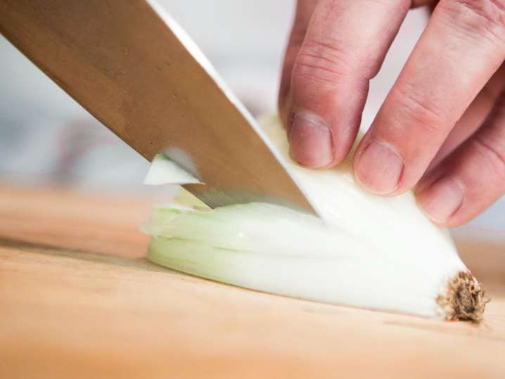 chef slicing an onion Shot