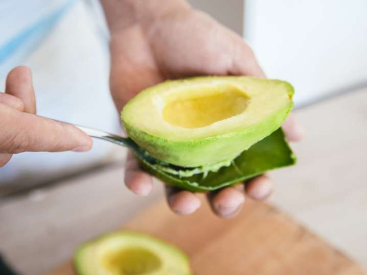 chef slicing fresh avocado Shot