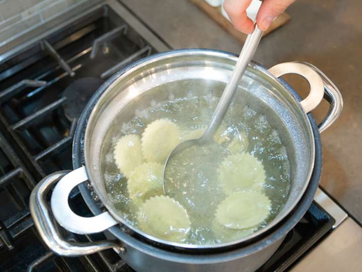 chef cooking ravioli in boiling water Shot