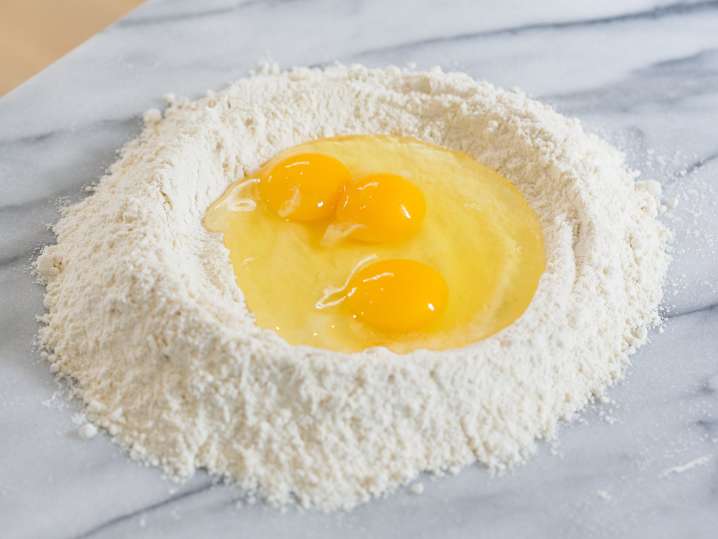 eggs and flour to make homemade pasta dough Shot