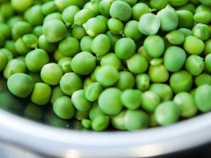 english peas in a white bowl Shot