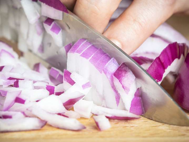 chef dicing red onion Shot