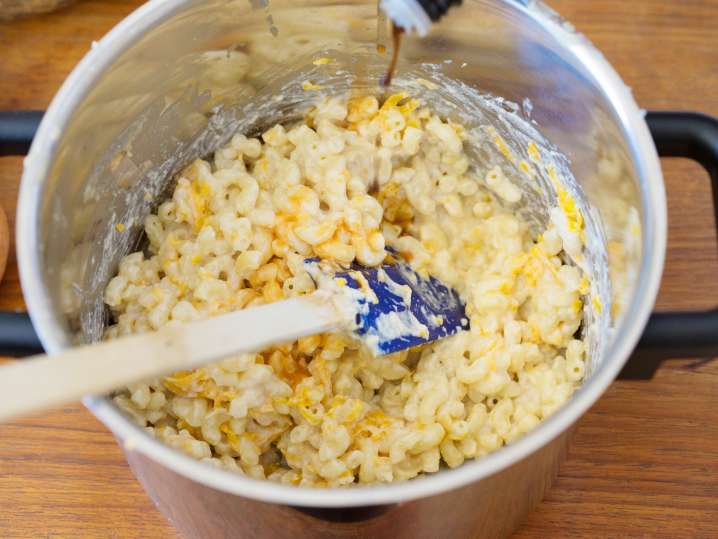 mixing macaroni noodles with cheese Shot