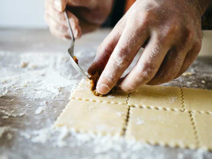 chef filling italian sausage and spinach ravioli Shot