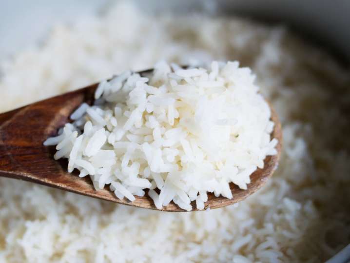 uncooked rice on a wooden spoon Shot