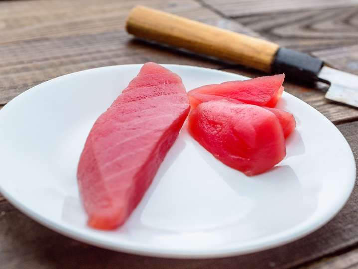 chef hand rolling sushi Shot