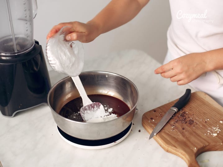 putting flour into chocolate batter