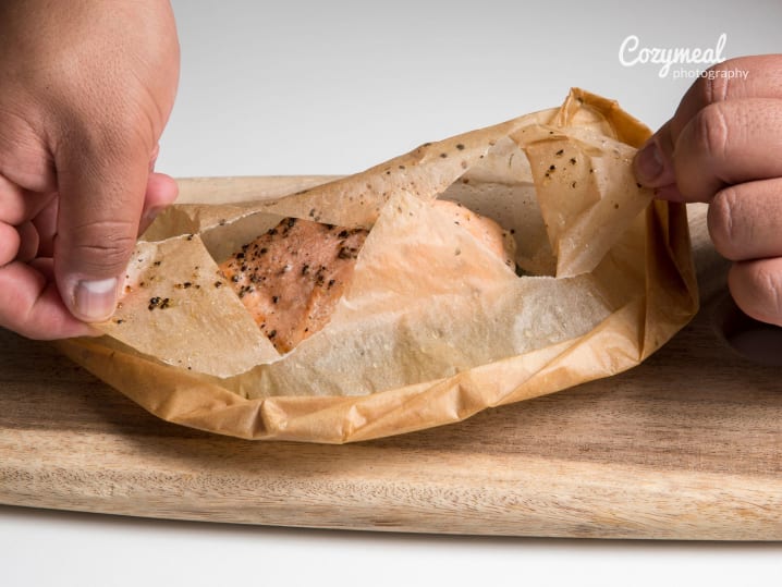 Wrapping salmon in parchment paper for en papillote.
