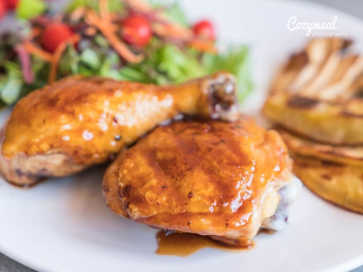 Pan-roasted chicken with mustard herb sauce, served with grilled vegetables.