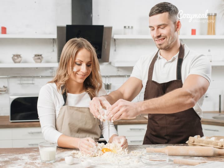 a couple making pasta dough together