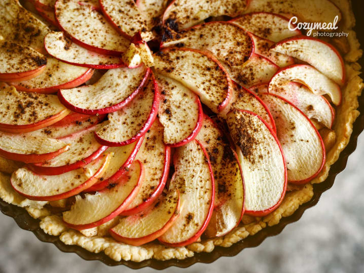 Spiced apple crostata with thinly sliced apples arranged in a rose pattern.