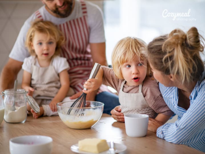 family is mixing batter for baking together