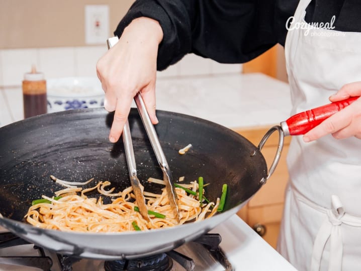 stir-frying pad Thai in a wok
