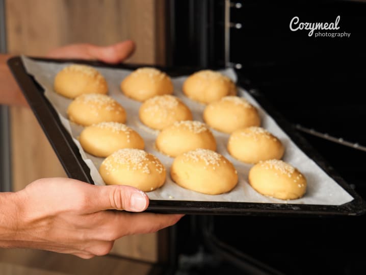 putting Parker House Rolls in the oven for baking