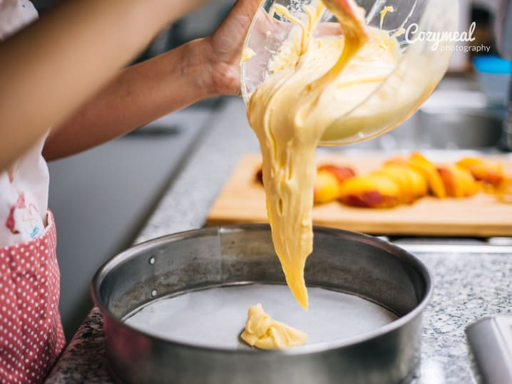 A baker pouring dough for pastry preparation