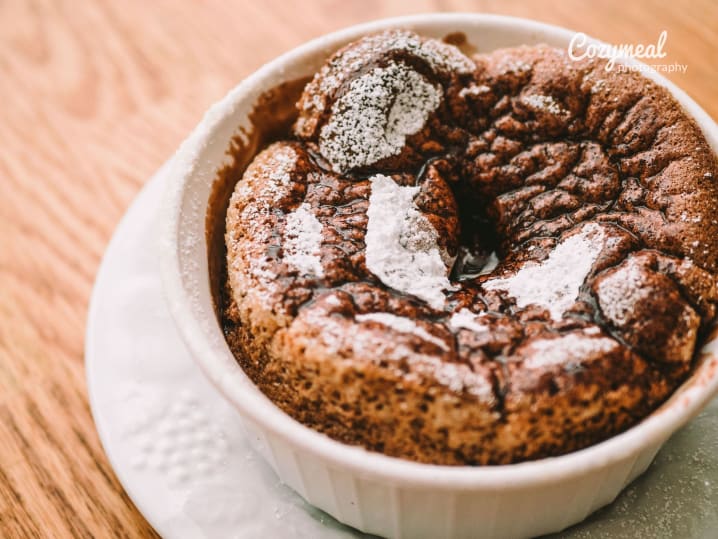A freshly baked chocolate soufflГ© dusted with powdered sugar