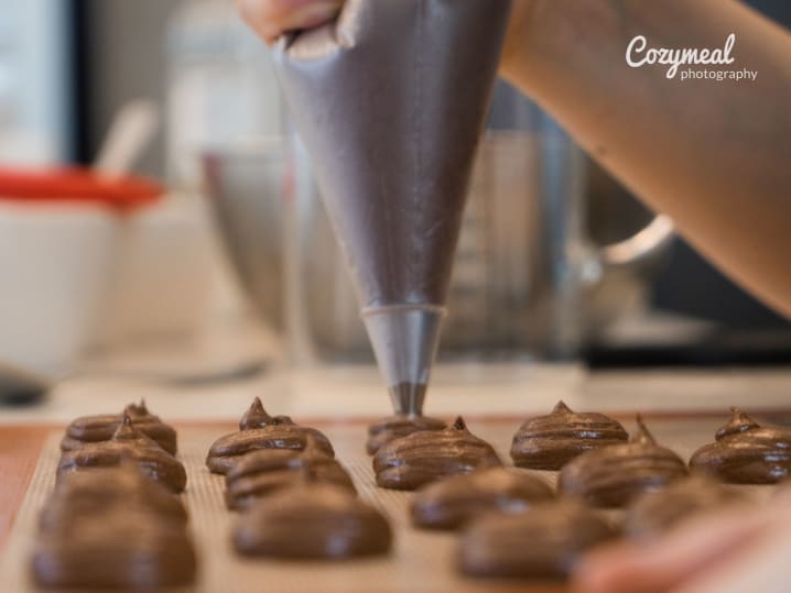 A piping bag used to create intricate designs for pastries on a baking sheet